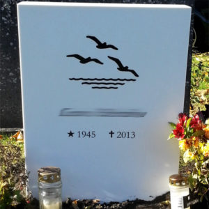 picture of installed peaceyard gravestone, model ada in glacier white color with standard base and round planter