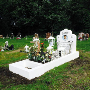 picture of installed peaceyard gravestone, custom model arwa in glacier white color with standard base, square planter and square full frame