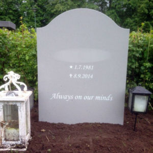 picture of installed peaceyard upright gravestone, model cora in dove material with customer graphics