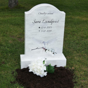 picture of installed peaceyard horizontal gravestone, model cora in everest material with customer graphics