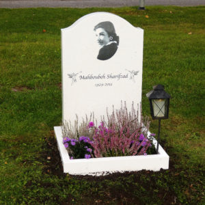 picture of installed peaceyard upright gravestone, model cora in glacier white color with customer graphics