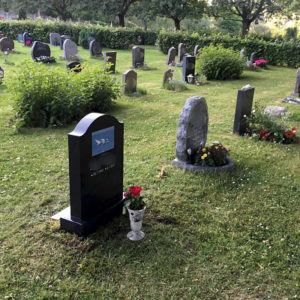 picture of installed peaceyard upright gravestone, model cora in night sky material with customer graphics