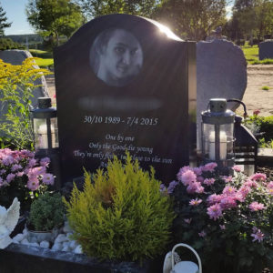 picture of installed peaceyard upright gravestone, model cora in night sky material with customer graphics