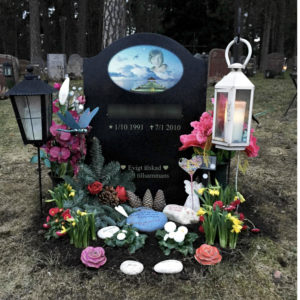 picture of installed peaceyard upright gravestone, model cora in night sky material with customer graphics