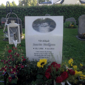 picture of installed peaceyard upright gravestone, model kitty in everest material with customer graphics