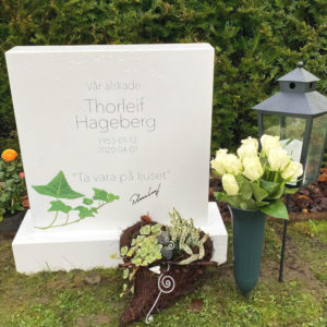 picture of installed peaceyard upright gravestone, custom model ada (shorter) in glacier white material with customer graphics and standard base