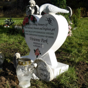 picture of installed peaceyard gravestone, model melody mini in glacier white material with standard base