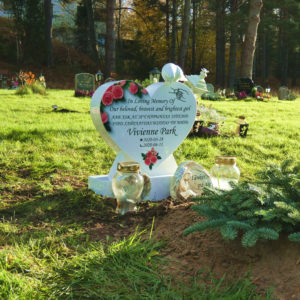 picture of installed peaceyard upright gravestone, model melody (mini) in glacier white material with customer graphics