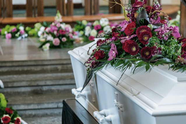 White coffin at funeral